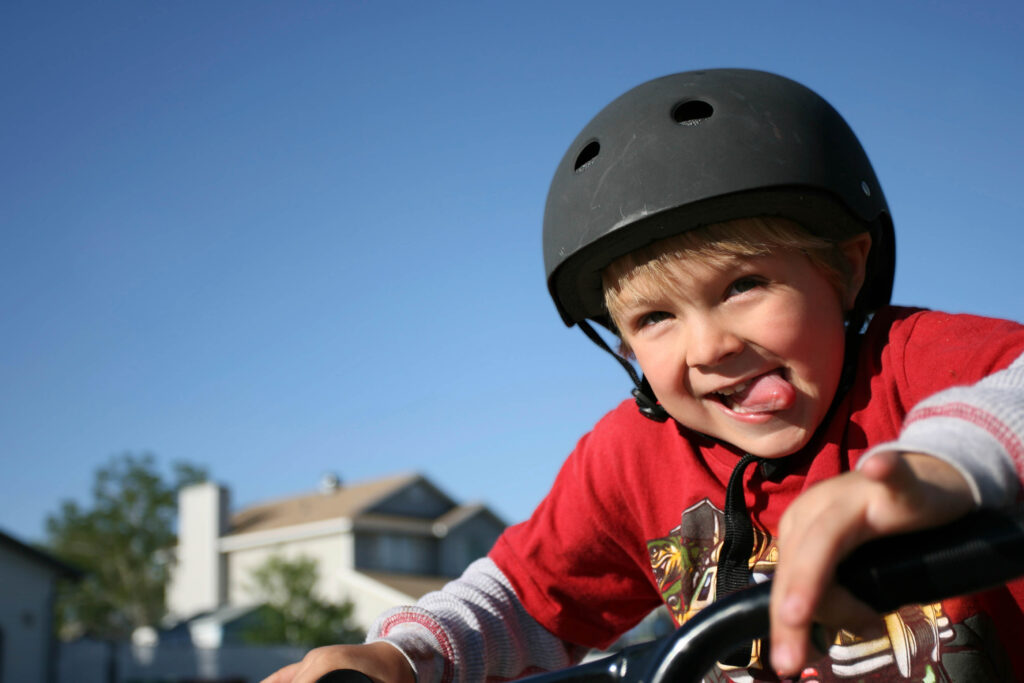 Child riding his bike with a helmet on